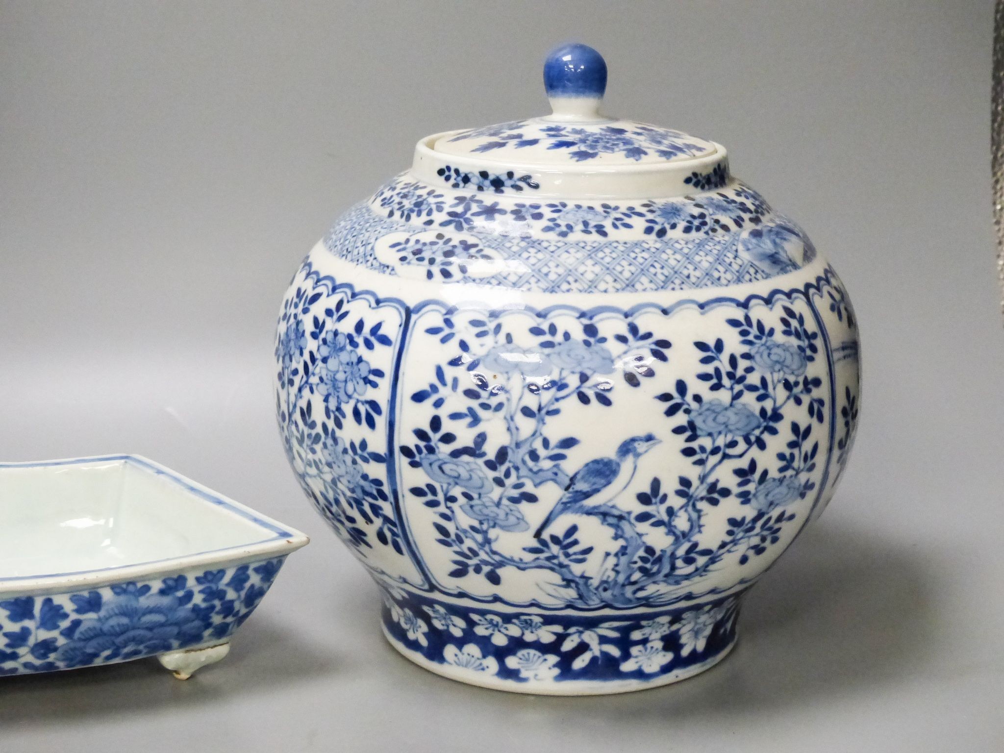 A 19th century Chinese blue and white jar and cover, four character Kangxi mark, 22cm high and a Chinese blue and white fan shape dish, 25.5cm